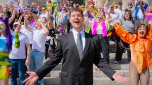 Bradley Jajo with community group in Guildhall Square