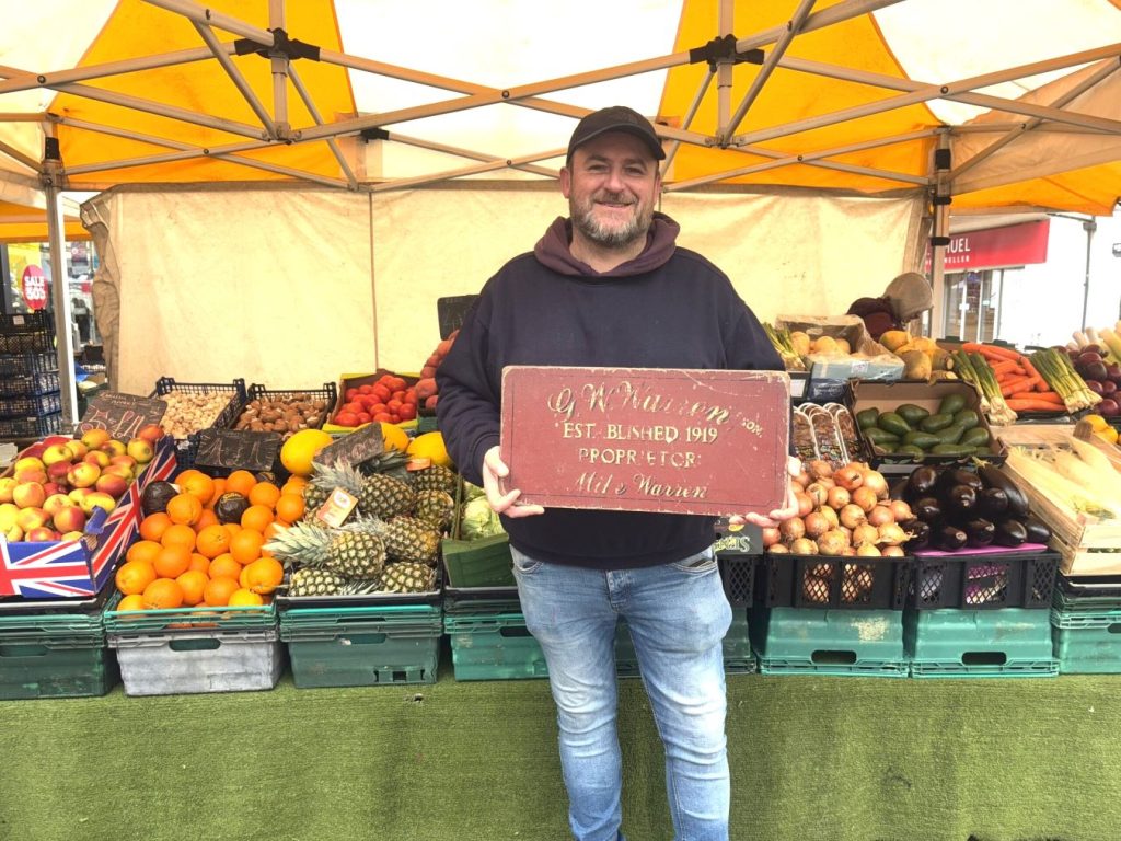 James Warren in front of fruit and veg stall